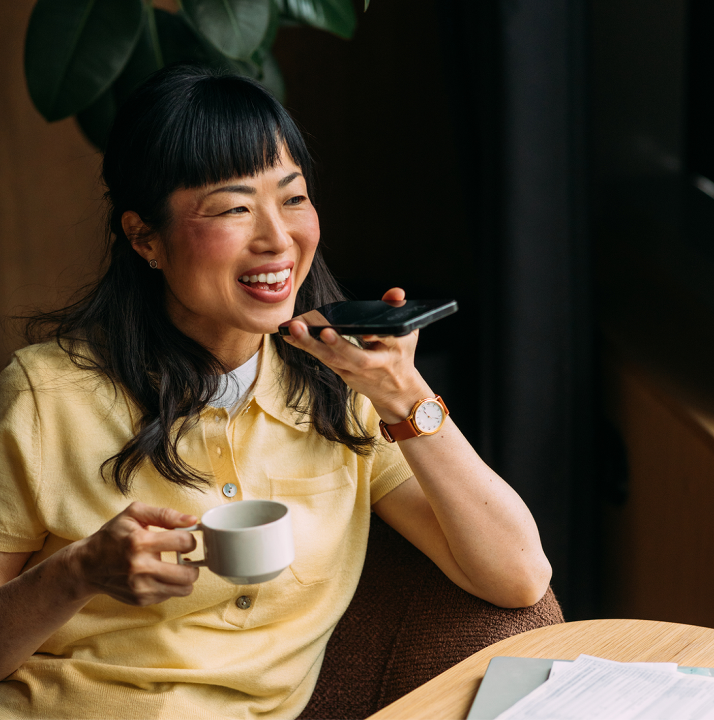 A woman smiling talking into her phone