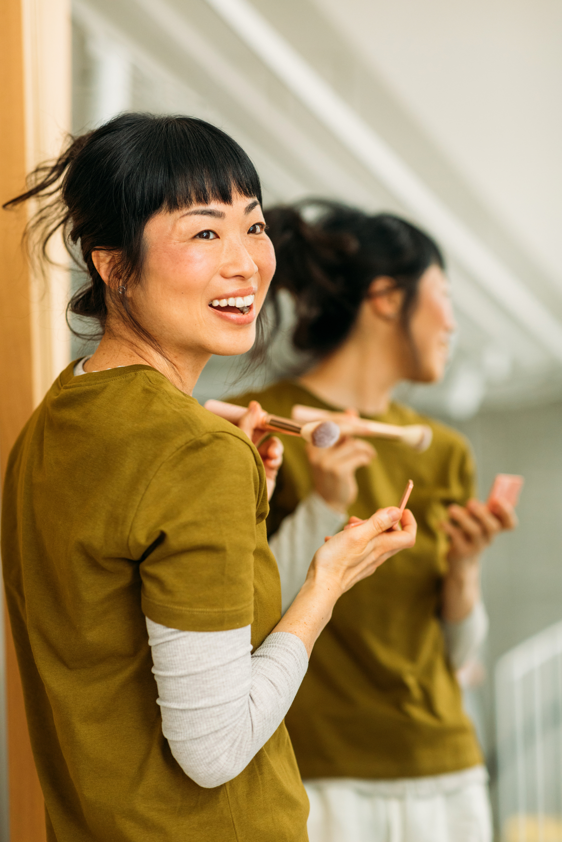 A woman smiling looking over her shoulder