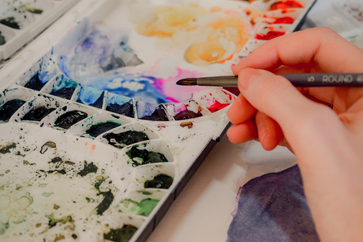 An image of a used watercolor palette